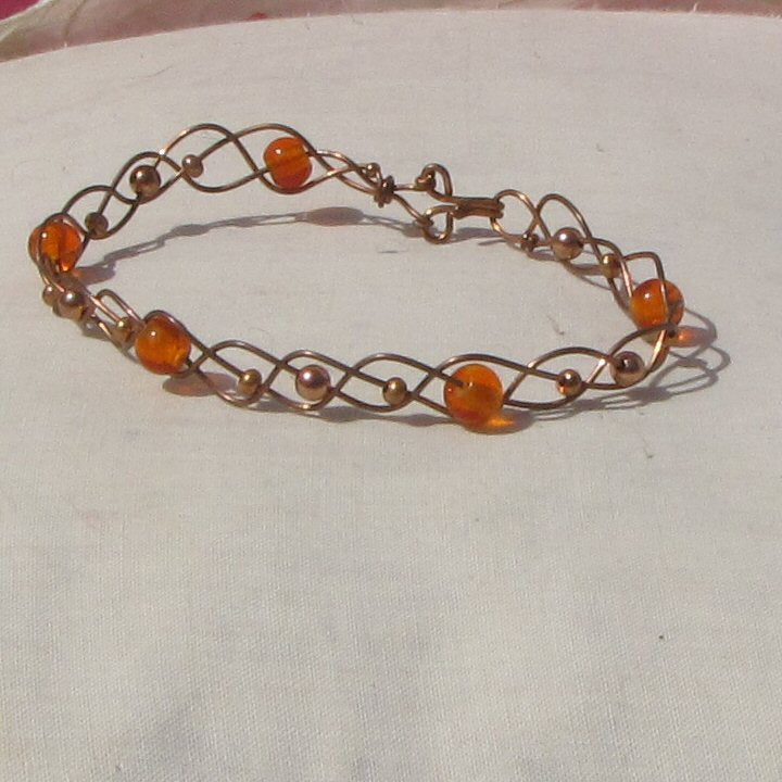 Copper and orange glass beads plaited bracelet