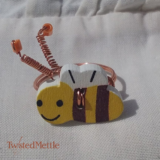Copper Bee ring, with copper twisted antenna topped with a peach coloured bead