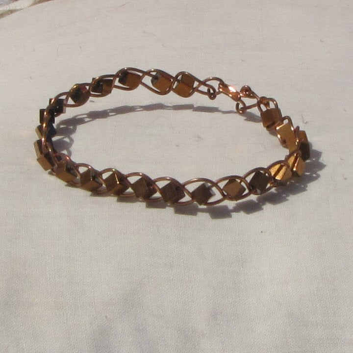 Copper plaited bracelet with copper covered hematite cube beads