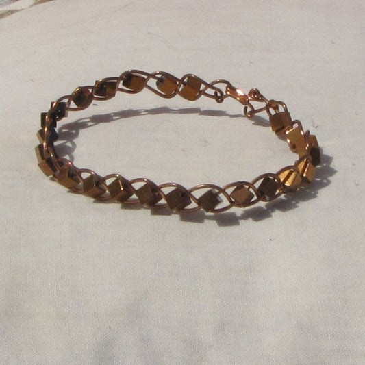 Copper plaited bracelet with copper covered hematite cube beads
