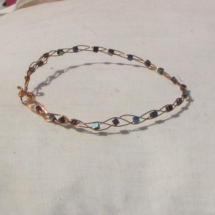 Copper plaited bracelet with shiny mermaid green, blue and purple coloured hematite cubes - detail
