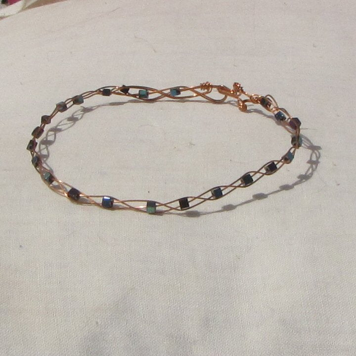 Copper plaited bracelet with shiny mermaid green, blue and purple coloured hematite cubes - detail