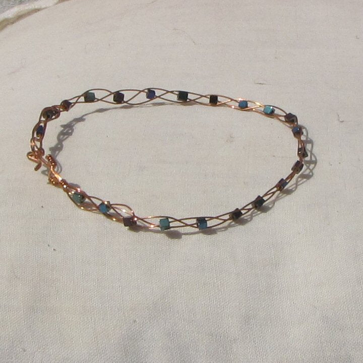 Copper plaited bracelet with shiny mermaid green, blue and purple coloured hematite cubes - detail