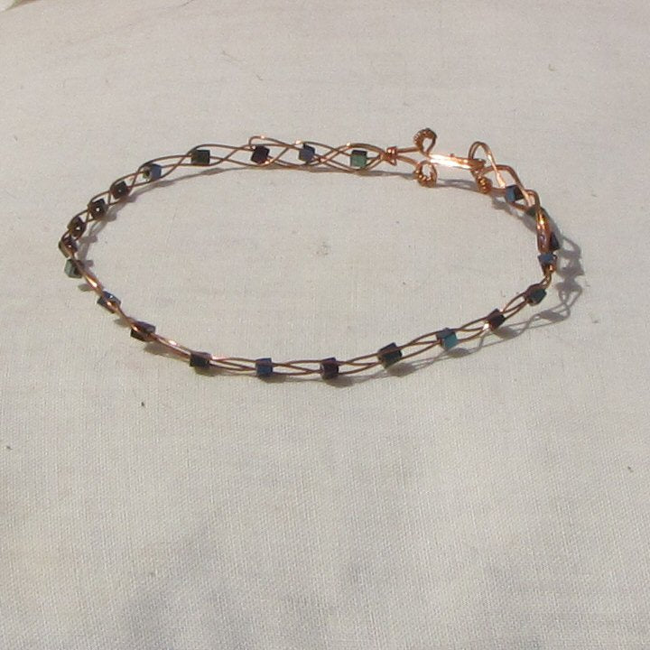 Copper plaited bracelet with shiny mermaid green, blue and purple coloured hematite cubes