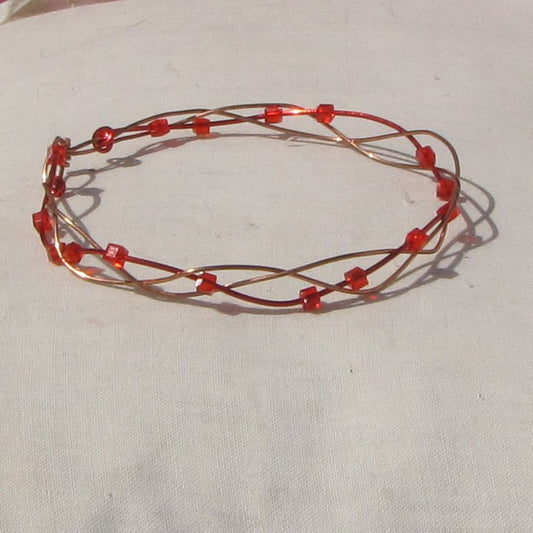 Copper and red coloured copper open plait bracelet with red square cubes