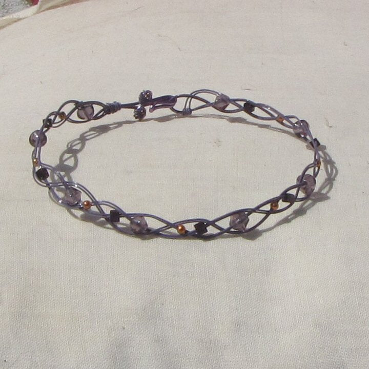 Double strand grey coloured copper plaited bracelet with amethyst, copper and purple beads
