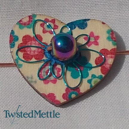 Heart shaped copper ring with iridescent bead, blue coloured copper flower