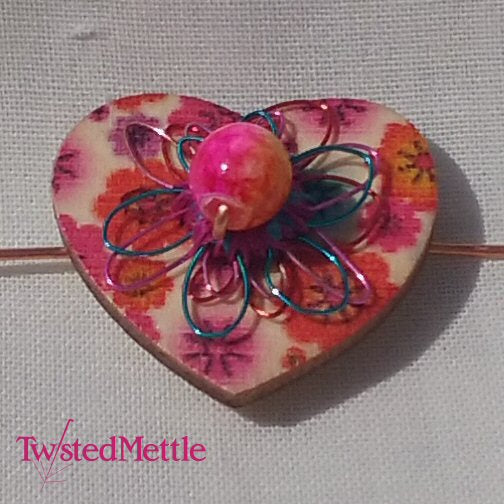 Heart shaped copper ring with pink + yellow glass bead and red, blue + pink coloured copper flowers