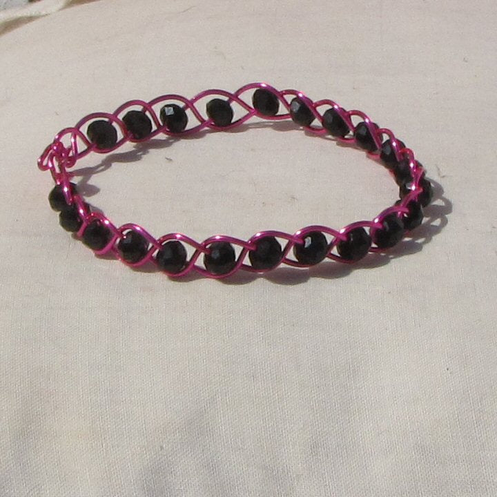 Hot shiny pink coloured copper plaited bracelet - detail