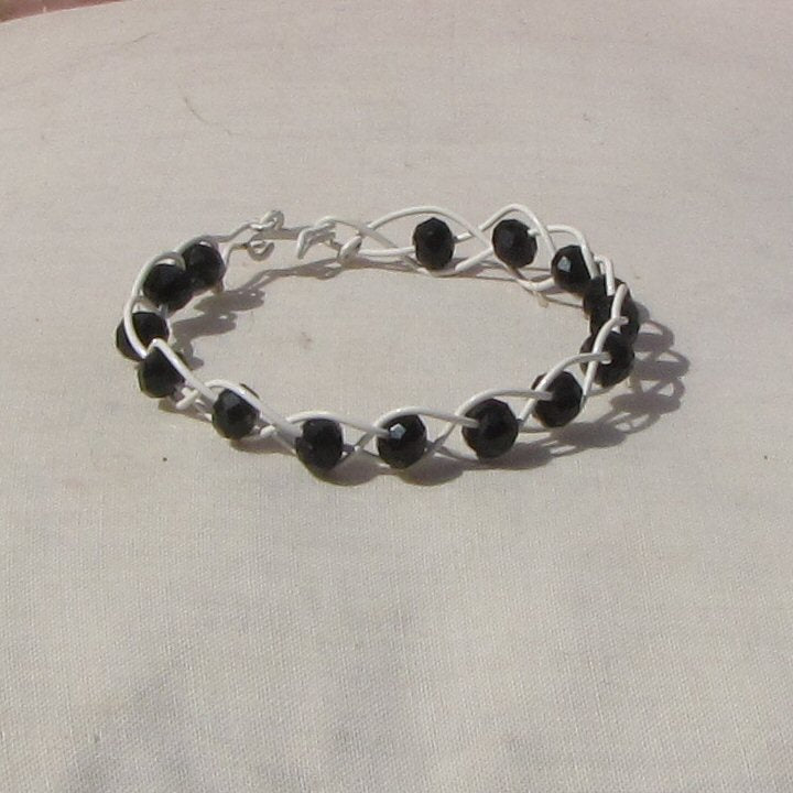 Ivory coloured copper plaited bracelet with black beads - detail