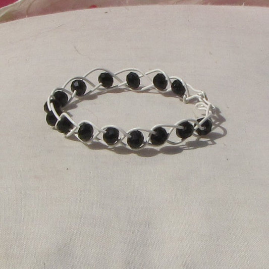 Ivory coloured copper plaited bracelet with black beads