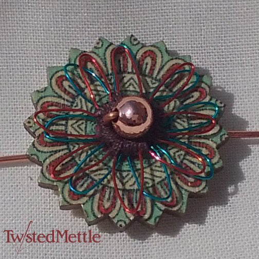 VWB. Central copper bead, a red and a blue coloured copper flower