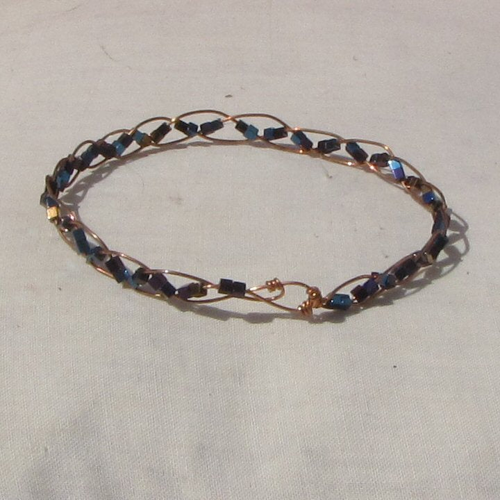 Delicate copper plaited bracelet with copper, blue + purple hematite cubes