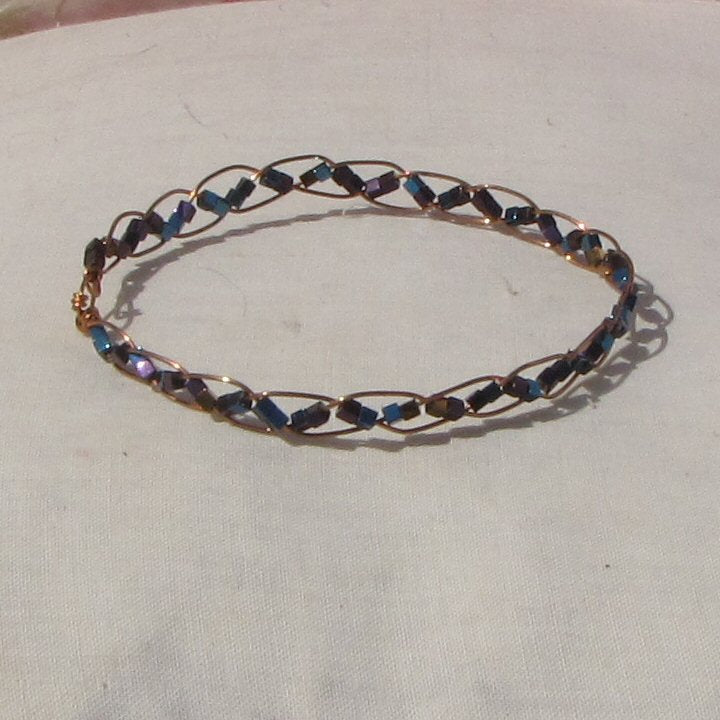 Delicate copper plaited bracelet with copper, blue + purple hematite cubes - detail