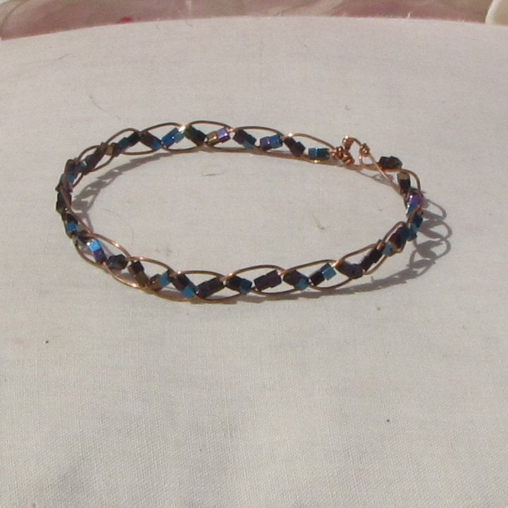 Delicate copper plaited bracelet with copper, blue + purple hematite cubes - detail